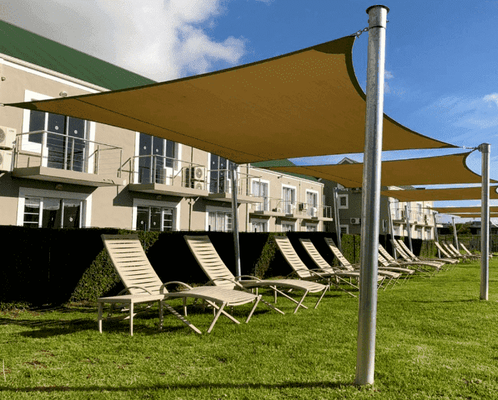 Sun shade sail to provide shade next to the pool
