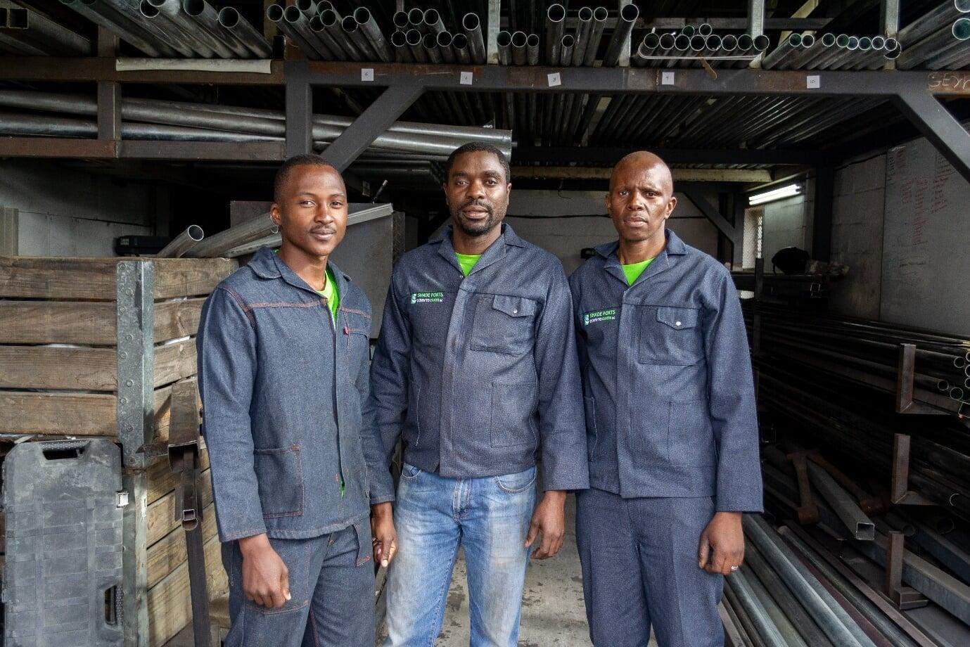 Fabrication team led by Lloyd, supported by Allen and Willie, producing in-house, custom-designed components for durable and precise shade structures.