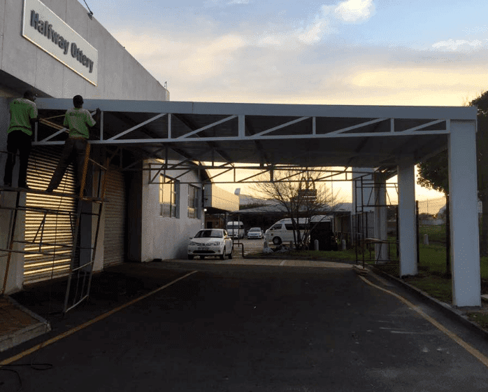 Down To Earth does car port shading for large warehouses 