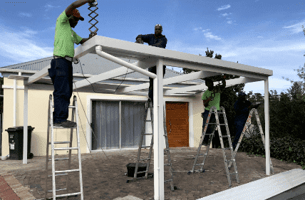 Our team actively installing a shade solution for a house